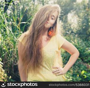 Pretty blonde outdoors. Face half hidden dy hair. Colorized image