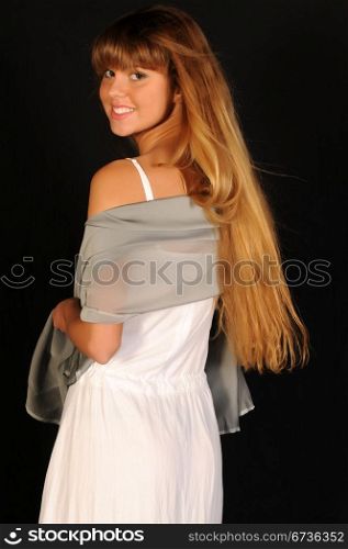 Pretty blonde teenage girl dressed in white
