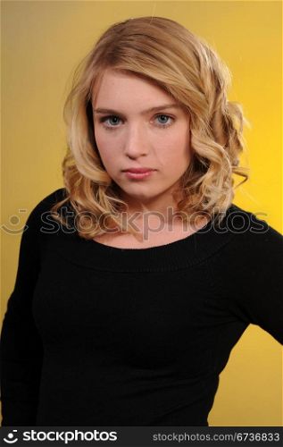 Pretty blonde teenager in a black sweater