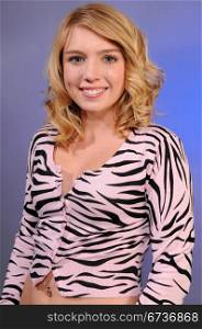 Pretty blonde teenager in a pink tiger stripe blouse
