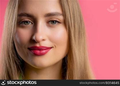 Pretty blonde woman, big lips on pink background. Smiling natural healthy girl lady with european appearance looking at camera. High quality photo. Pretty blonde woman, big lips on pink background. Smiling natural healthy girl