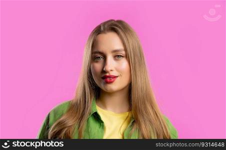 Pretty blonde woman portrait on pink studio background. Colorful outfit. Smiling beautiful lady with european appearance looking at camera. High quality photo. Pretty blonde woman portrait on pink studio background. Colorful outfit. Smiling