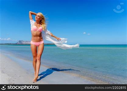 Pretty blonde woman standing on the beach. Pretty blonde woman on the beach