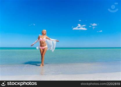Pretty blonde woman standing on the beach. Pretty blonde woman on the beach