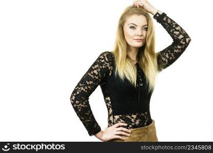 Pretty blonde woman wearing fashionable black lace top with long sleeve. Style of fashion model.. Woman wearing stylish lace top