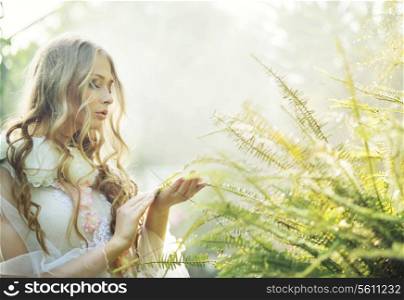 Pretty blonde woman with the green fern
