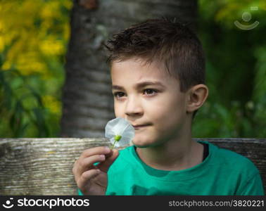 Pretty boy looking at camera outdoors shot