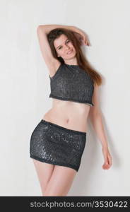 Pretty brown haired girl in a skimpy sequined blouse and skirt