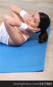 Pretty brown-haired woman doing situps
