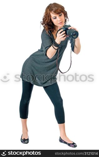 Pretty brunette checks the image of her last shot on the back of her digital camera.