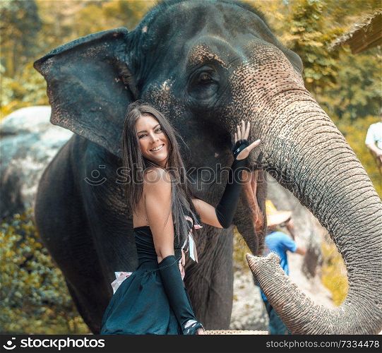 Pretty, brunette elephant trainer with her pet