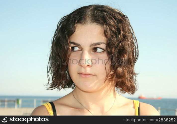 Pretty brunette girl at the sea.