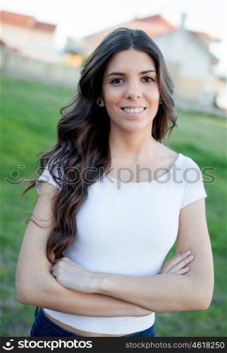 Pretty brunette girl smiling while resting in the park
