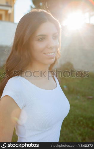 Pretty brunette girl smiling while resting in the park