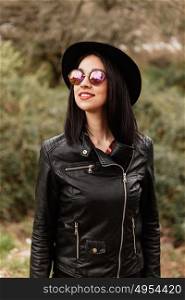 Pretty brunette girl with leather jacket and red lips