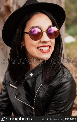 Pretty brunette girl with leather jacket and red lips