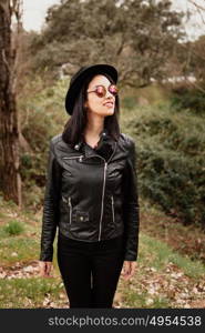 Pretty brunette girl with leather jacket and red lips