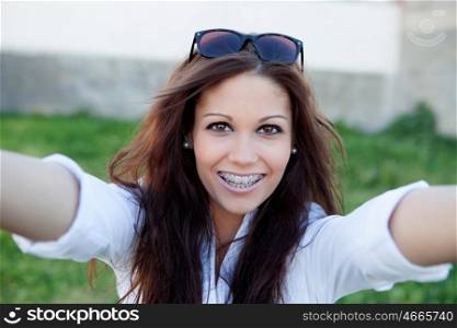 Pretty brunette in the park by becoming a photo with mobile