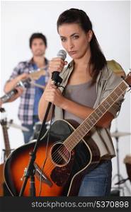 pretty brunette singing with band
