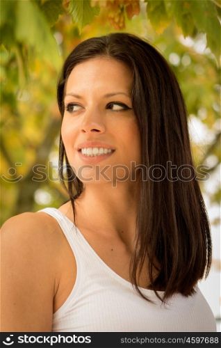 Pretty brunette woman in autumn in a park