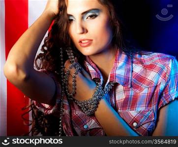 pretty brunette woman wearing dress on dark background