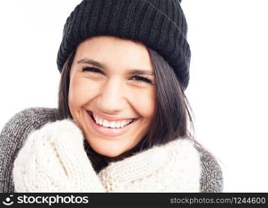 pretty brunette woman with a woolen hat a sweater and gloves smiling and cheerful