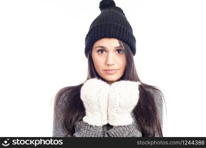 pretty brunette woman with a woolen hat a sweater and gloves that has cold