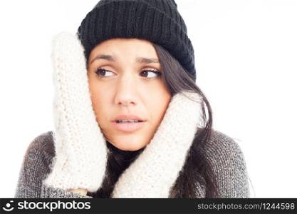 pretty brunette woman with a woolen hat a sweater and gloves that has cold