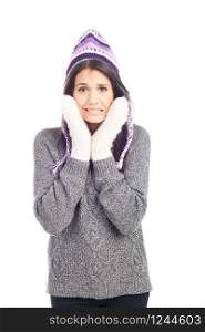 pretty brunette woman with a woolen Peruvian hat a sweater and gloves that has cold