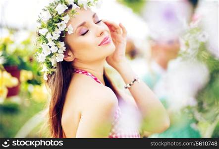 Pretty brunette woman with the colorful wreath on the head