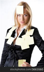 pretty business woman with black jacket and some yellow piece paper on her body, she looks in to the lens with endearing expression and her right hand is on the right hip