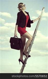 pretty business woman with work bag stepping ladder of the success with ambition
