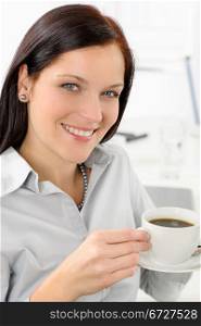 Pretty businesswoman enjoy cup of coffee at modern office