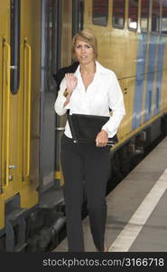 Pretty businesswoman getting on the train