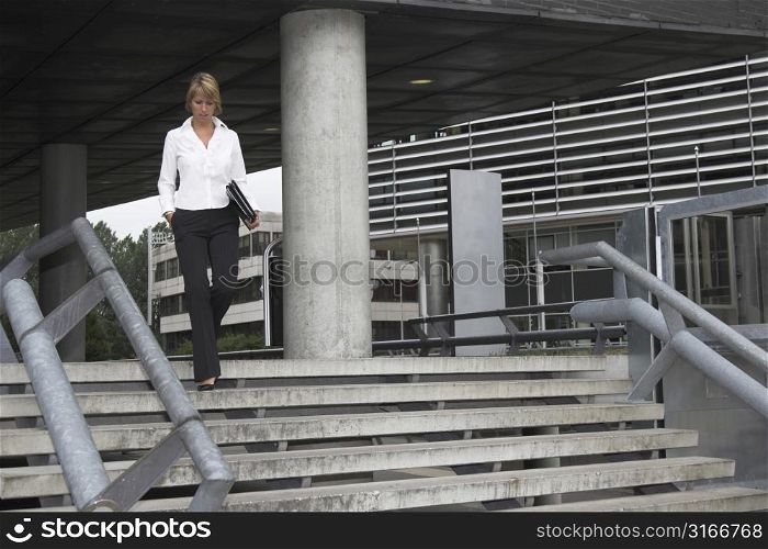 Pretty businesswoman leaving the office