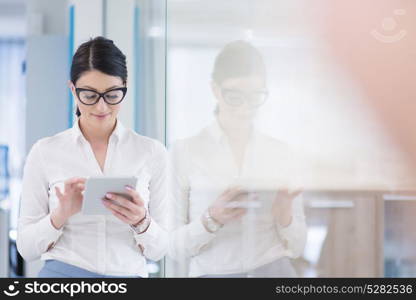 Pretty Businesswoman Using Tablet In front of startup Office Interior