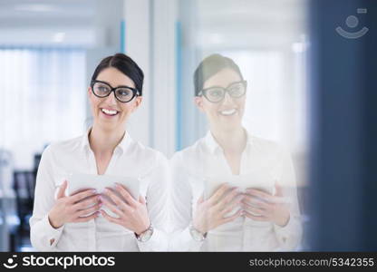 Pretty Businesswoman Using Tablet In front of startup Office Interior