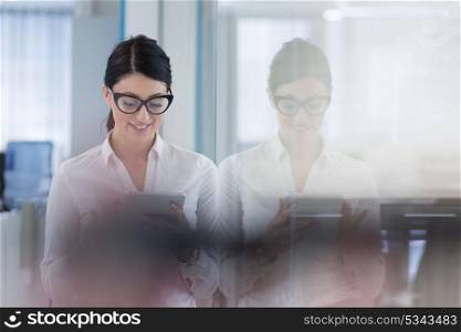 Pretty Businesswoman Using Tablet In front of startup Office Interior