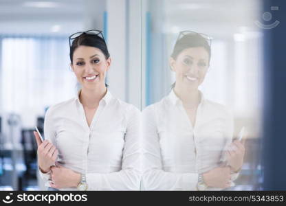 Pretty Businesswoman Using Tablet In front of startup Office Interior