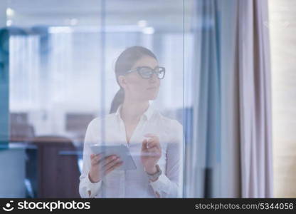 Pretty Businesswoman Using Tablet In front of startup Office Interior