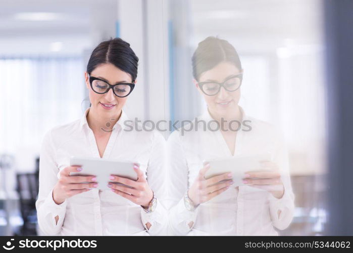 Pretty Businesswoman Using Tablet In front of startup Office Interior