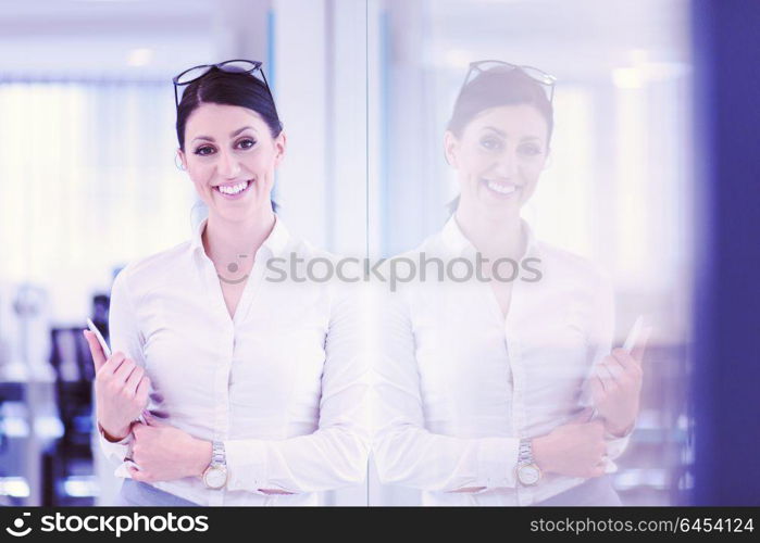 Pretty Businesswoman Using Tablet In front of startup Office Interior