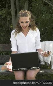 Pretty businesswoman working in the park