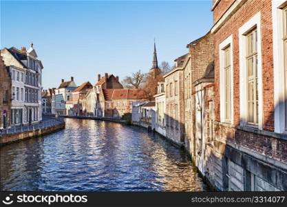 Pretty canal scene with beautiful architecture in Bruges Belgium.