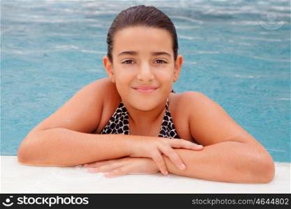 Pretty child girl swimming in the pool