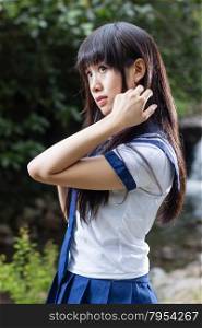 Pretty Chinese high school girl outside