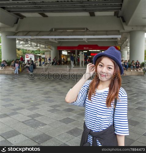 Pretty Chinese woman outside MRT subway station in Taipei