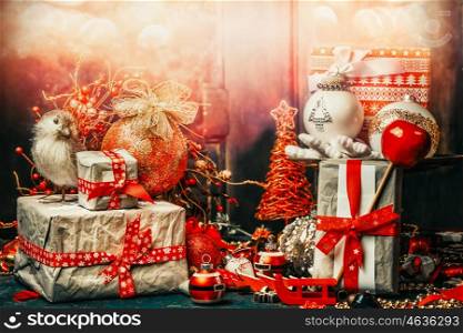 Pretty Christmas card with festive gifts, bird,decoration and balls . Holiday bokeh lighting, retro styled