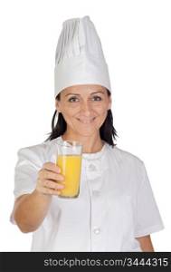 Pretty cook girl with a glass of orange juice isolated on white background