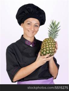 Pretty cook woman with pineapple isolated on purple background